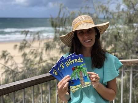 Author Christine Junge holds copies of Alfredo